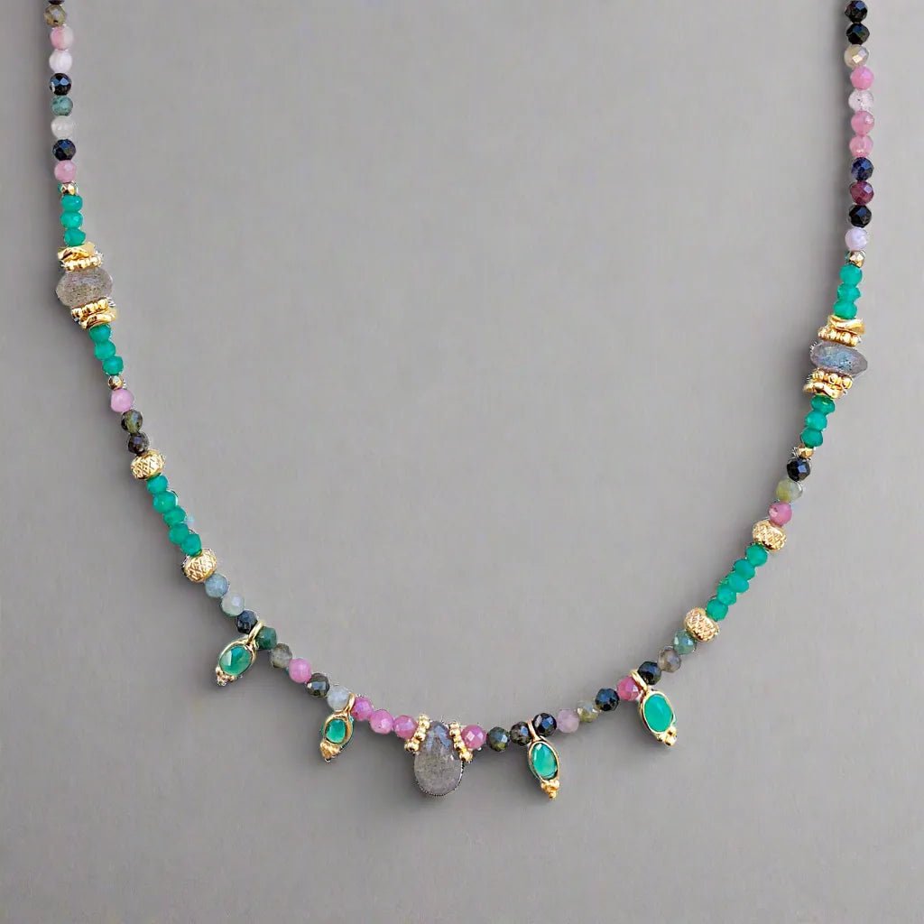 Necklace with multicolored beads on a gray background