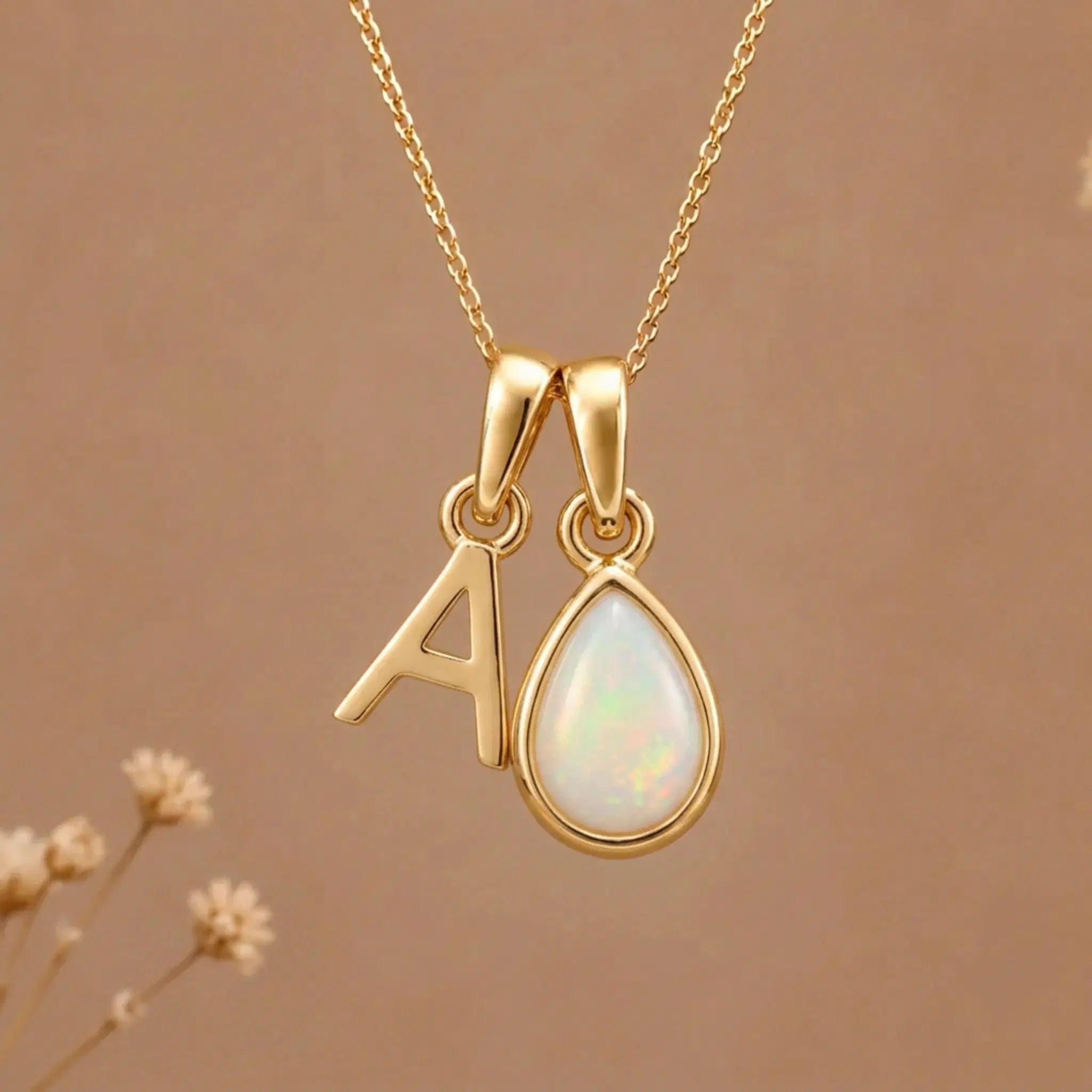Gold Initial A Pendant and October birthstone Natural Opal Necklace against a warm background