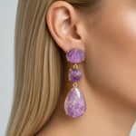 Gold amethyst drop earring worn, showing oval, cushion and pear-shaped natural purple stones.
