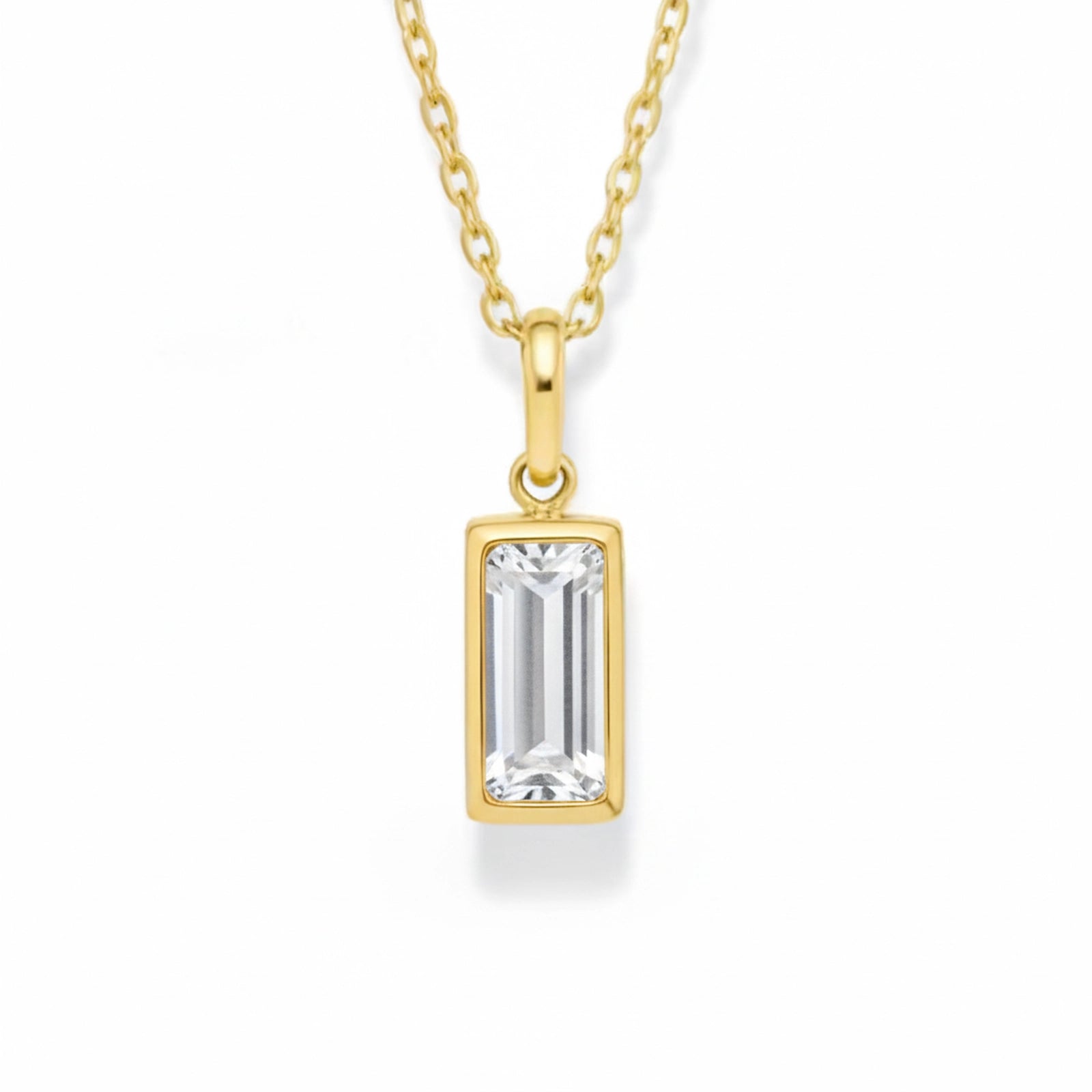 gold april birthstone necklace with clear cubic zirconia on a white background.