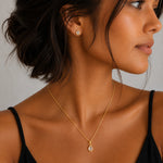 Model wearing Gold April Birthstone Jewellery set featuring Clear Quartz Stud Earrings and matching Clear Quartz pendant necklace