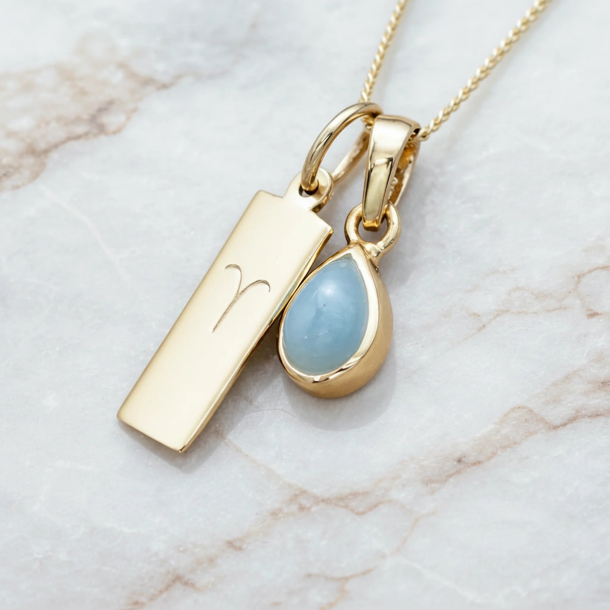 Gold March Birthstone Necklace with a pear-shaped natural Aquamarine gemstone pendant and Aries Zodiac pendant