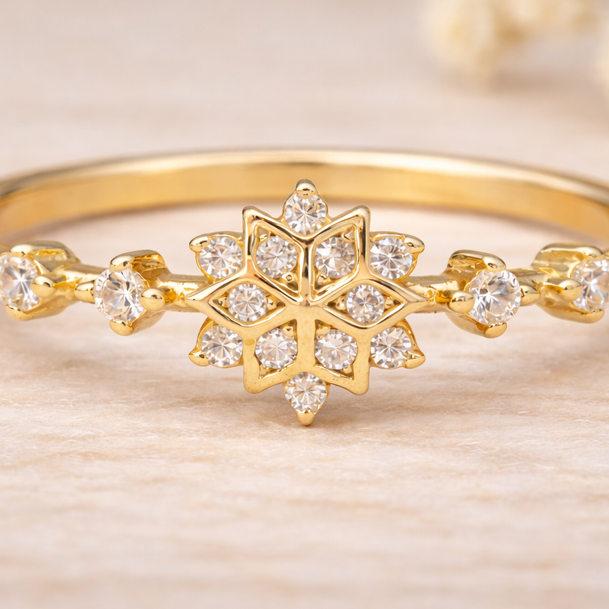 macro image of Gold ring with snowflake design on a light wooden background