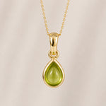 august birthstone gold teardrop pendant necklace featuring a light green natural peridot gemstone on a delicate gold chain