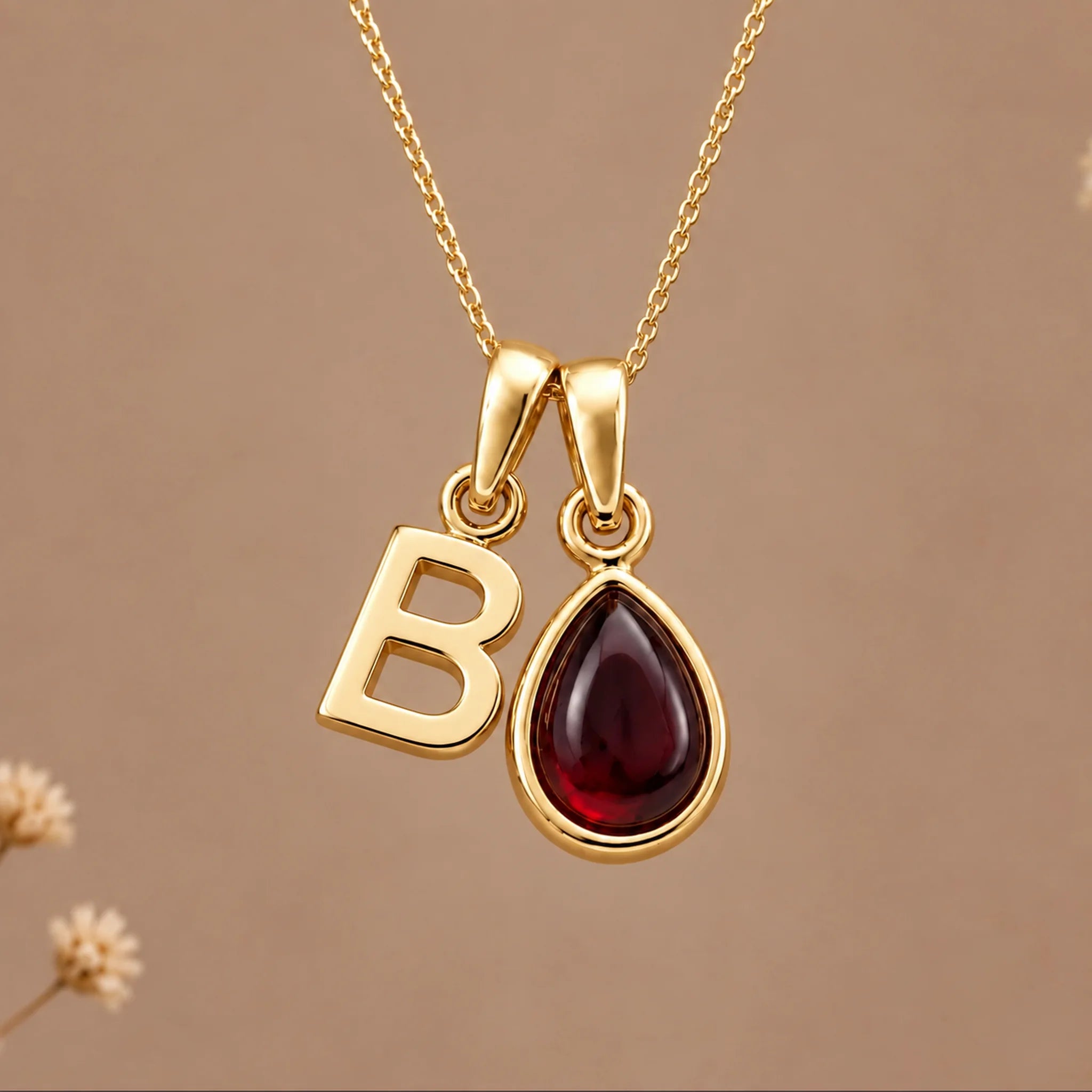 Gold initial B necklace with a natural January garnet