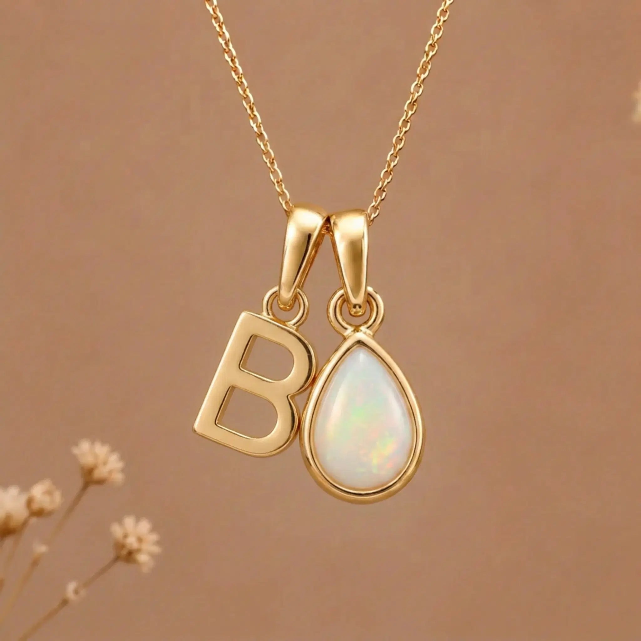 Gold Initial B Pendant and October birthstone Natural Opal Necklace against a warm background