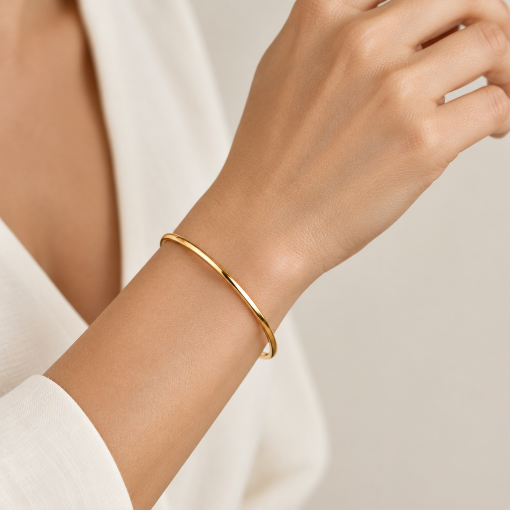 Waterproof 3mm gold polished bangle bracelet being worn
