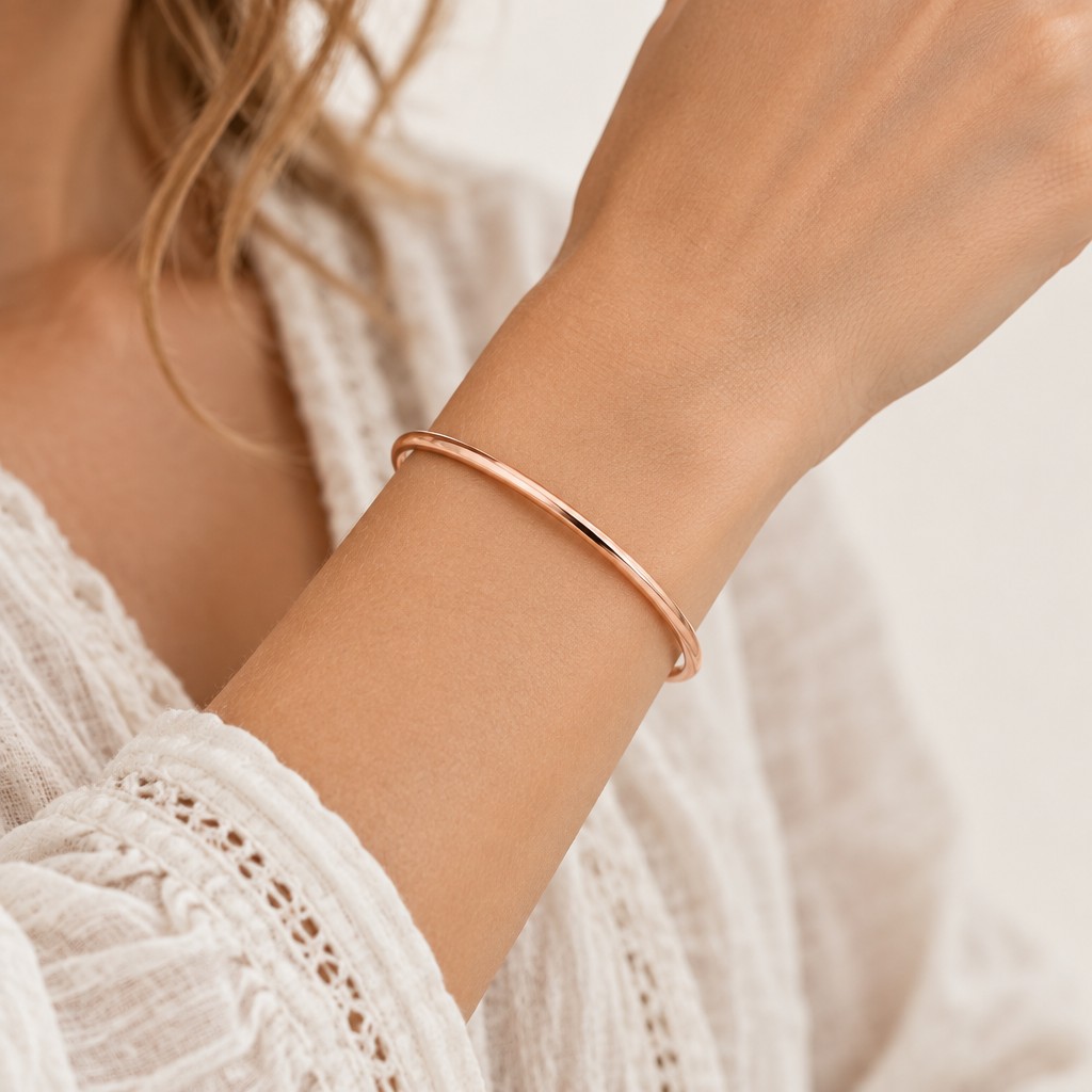 Thin 3mm minimalist classic bangle bracelet worn on the wrist with a white lace top