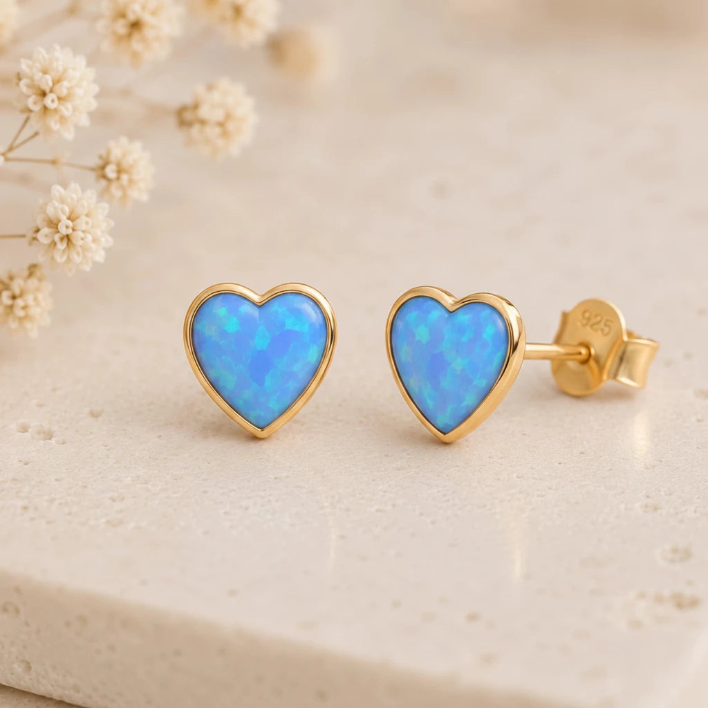 Gold stud earrings with blue opal hearts