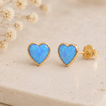Gold stud earrings with blue opal hearts