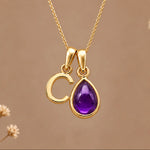 Gold initial C necklace with a natural February amethyst