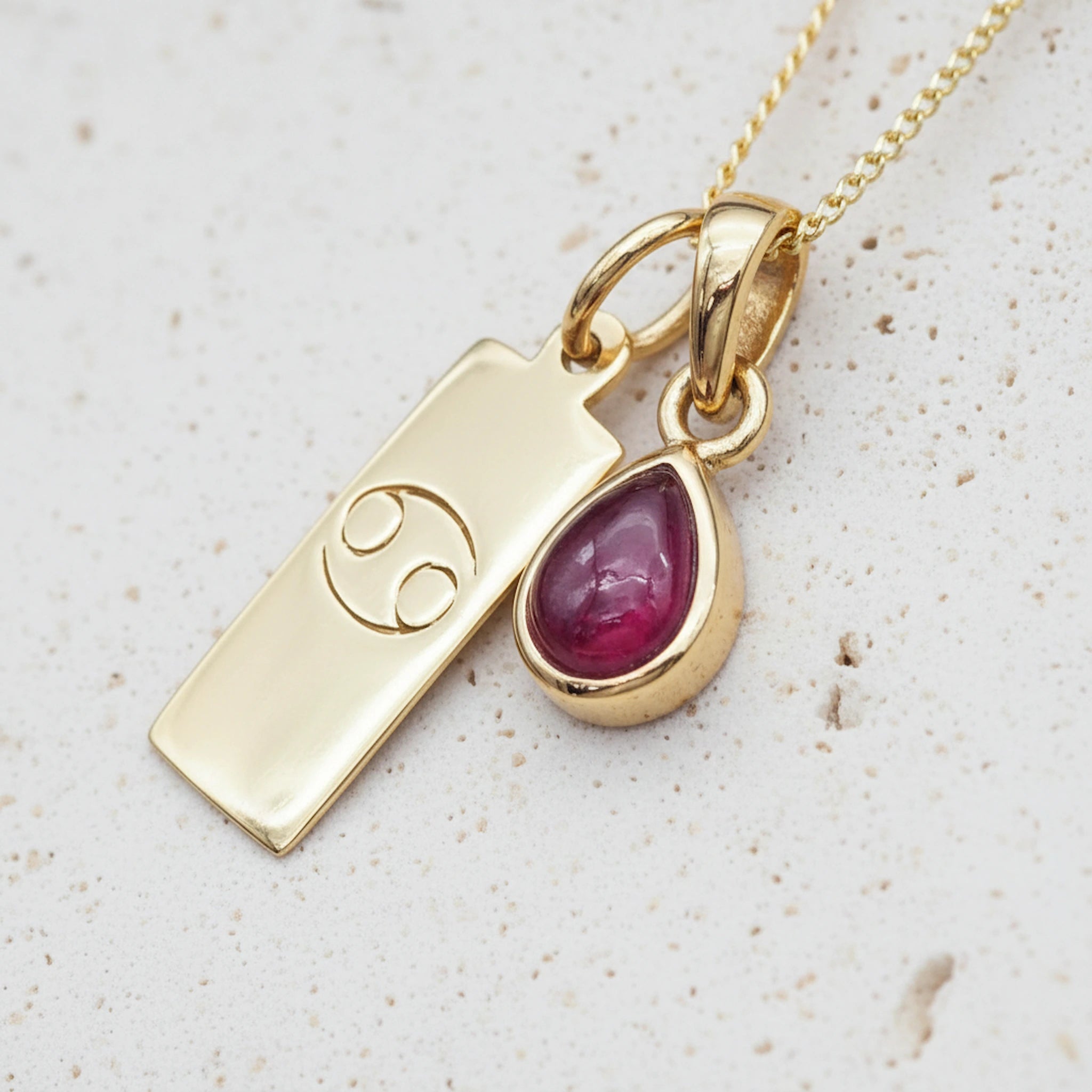 Gold July Birthstone necklace with a pear-shaped natural Ruby pendant and a Cancer zodiac pendant