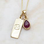 Gold July Birthstone necklace with a pear-shaped natural Ruby pendant and a Cancer zodiac pendant