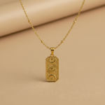 Pendant necklace with a gold celestial charm featuring sun and eye motif on a delicate chain