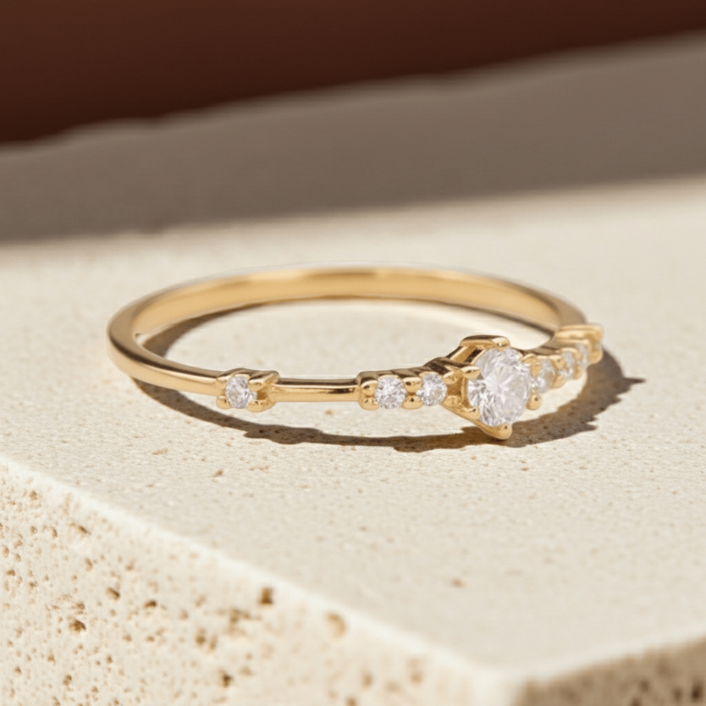 Gold ring with cubic zirconias on a beige stone surface