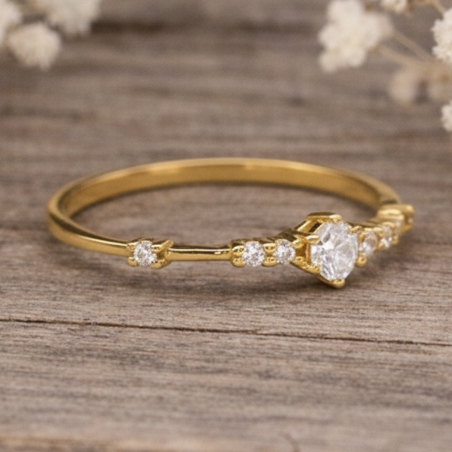 Gold ring with czs on a wooden surface