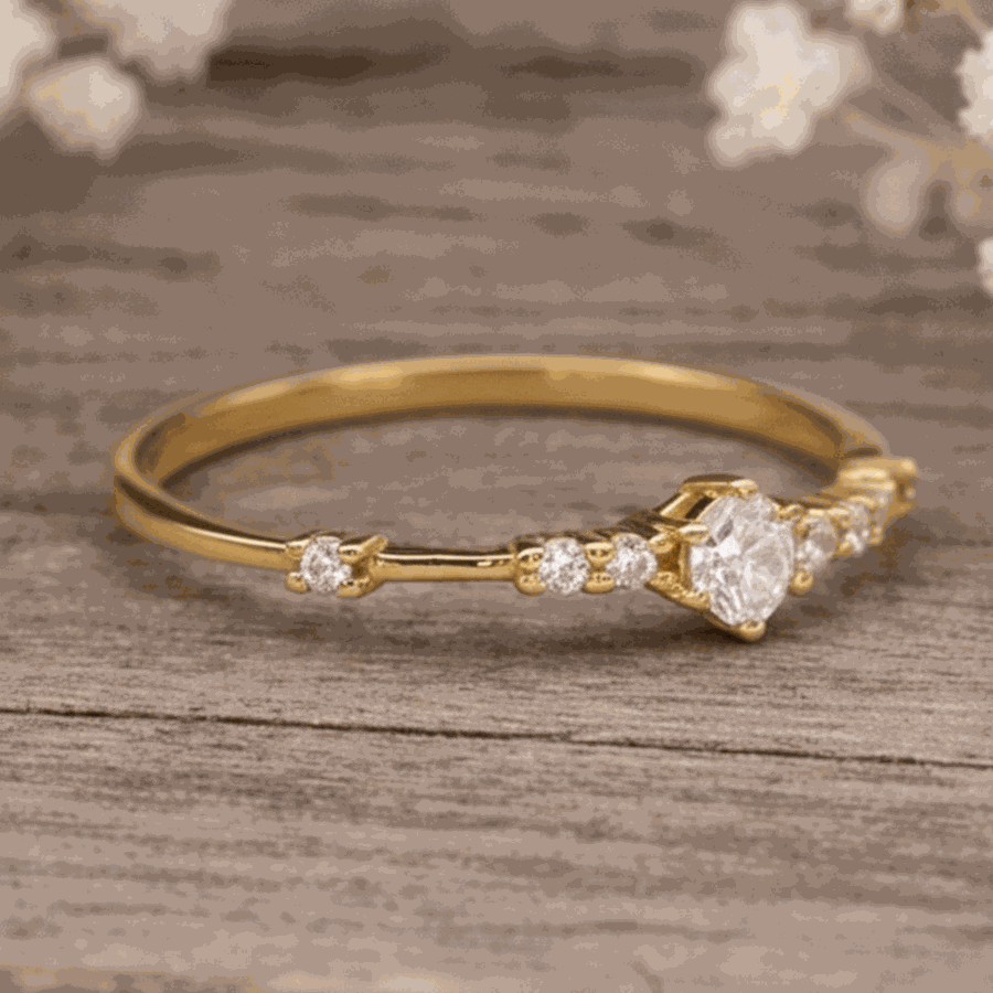 Gold ring with czs on a wooden surface