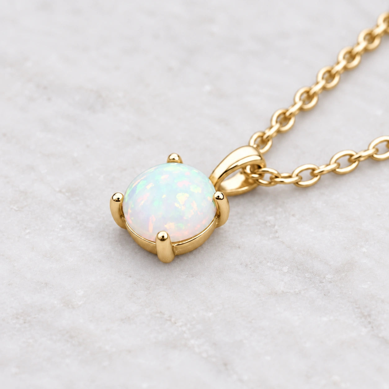Gold necklace with an white opal pendant on a wooden background