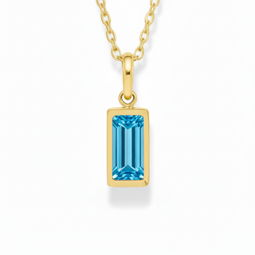 Gold necklace with a blue gemstone pendant on a white background