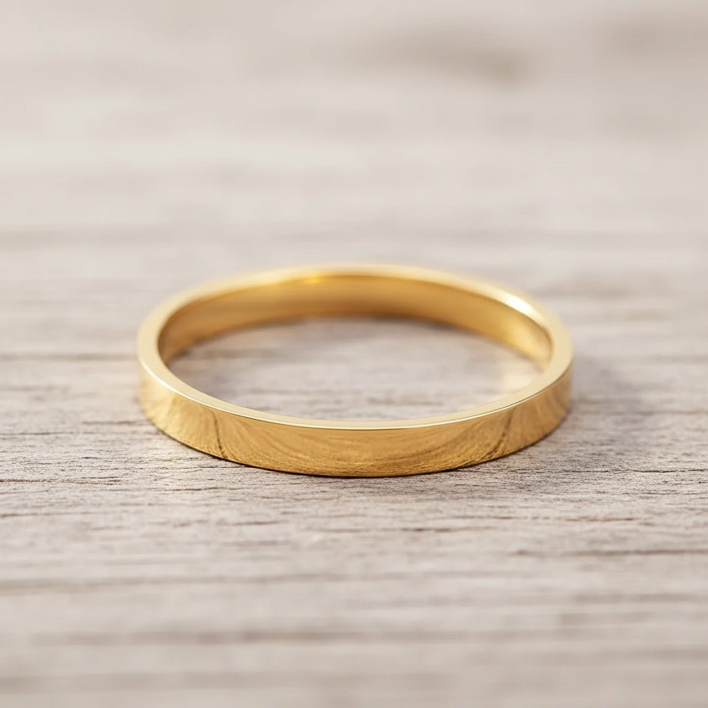 Gold band ring on a wooden surface