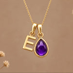 Gold initial E necklace with a natural February amethyst