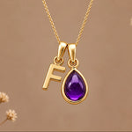 Gold initial F necklace with a natural February amethyst