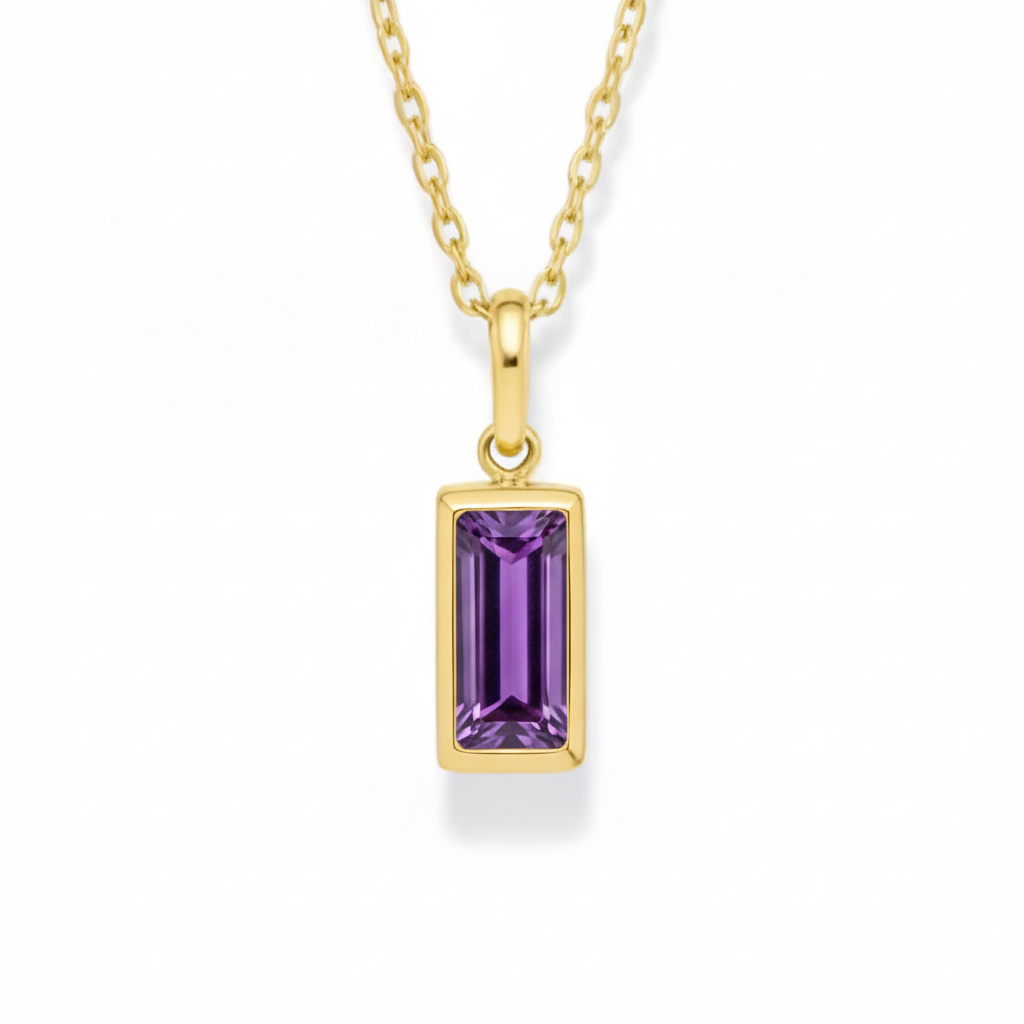Gold necklace with a purple gemstone pendant on a white background