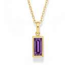 gold february birthstone necklace with purple cubic zirconia on a white background.