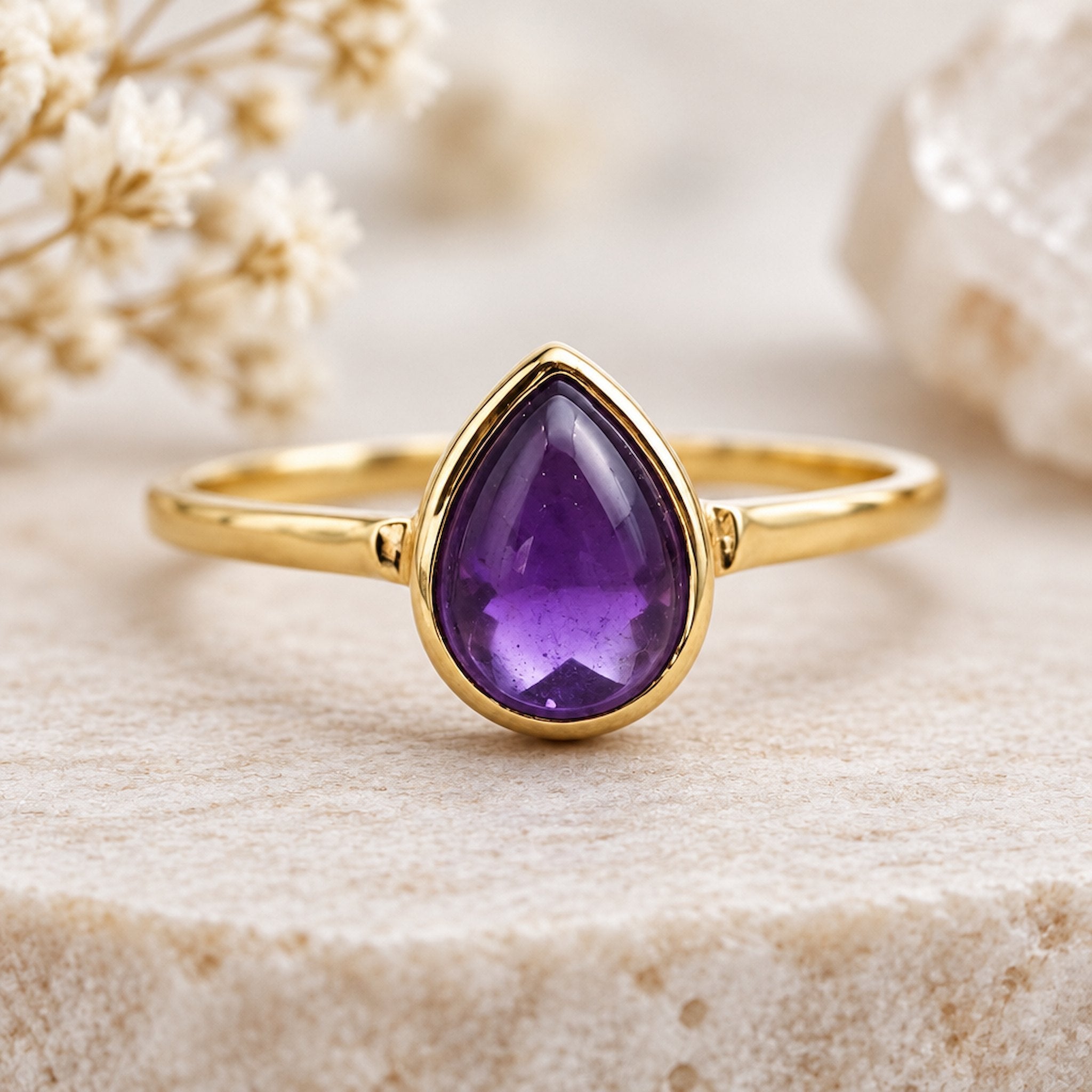 Gold February Birthstone Ring with a pear-shaped natural amethyst gemstone as a meaningful birthstone jewellery gift for her