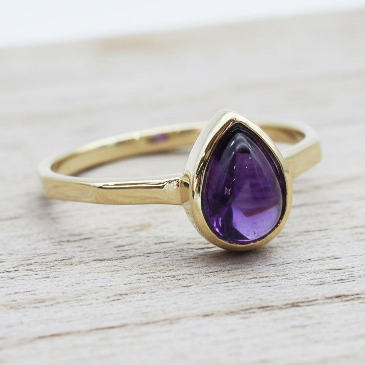 Gold February birthstone ring with pear-shaped natural amethyst gemstone as a meaningful birthstone jewellery gift for her