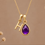 Gold initial H necklace with a natural February amethyst