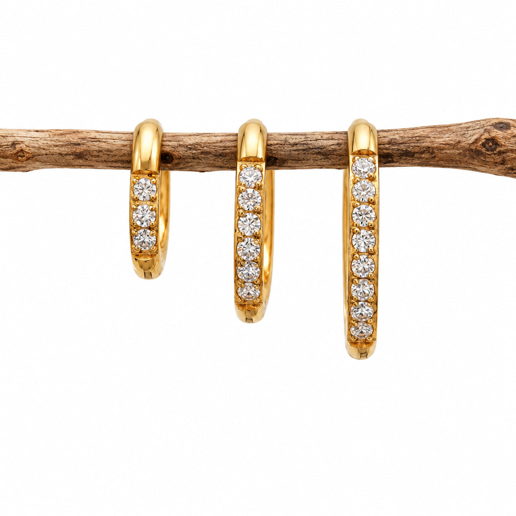 Three gold waterproof pavé huggie hoop earrings in three sizes