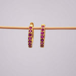 Gold Dainty Huggie Earrings with red cubic zirconias