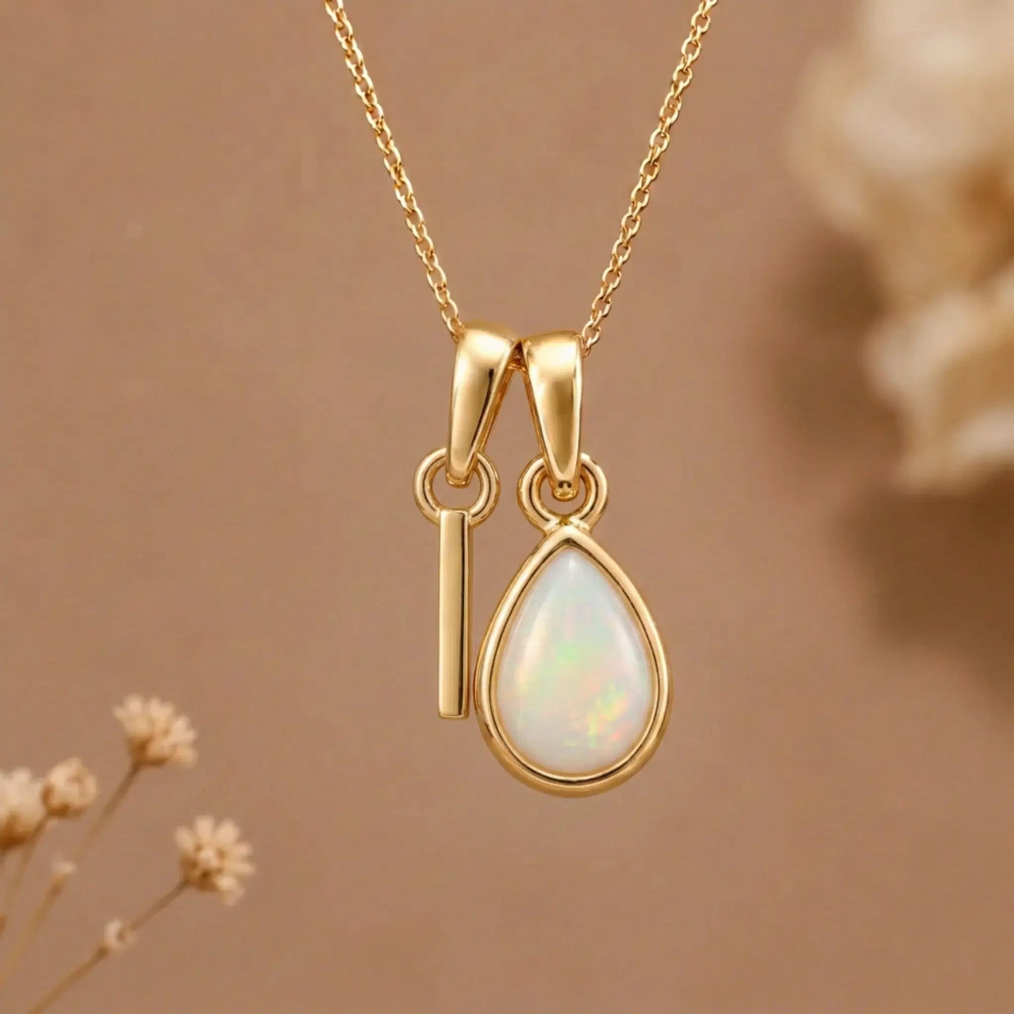 Gold Initial I Pendant and October birthstone Natural Opal Necklace against a warm background