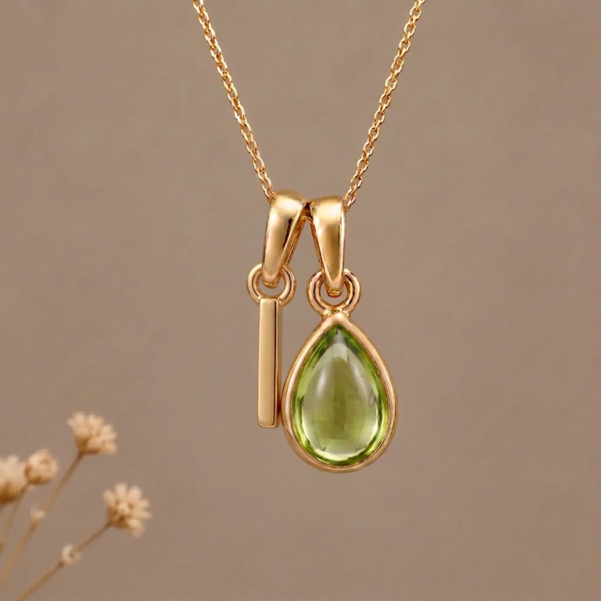 Gold Initial I Pendant and August birthstone Natural Peridot Necklace against a warm background
