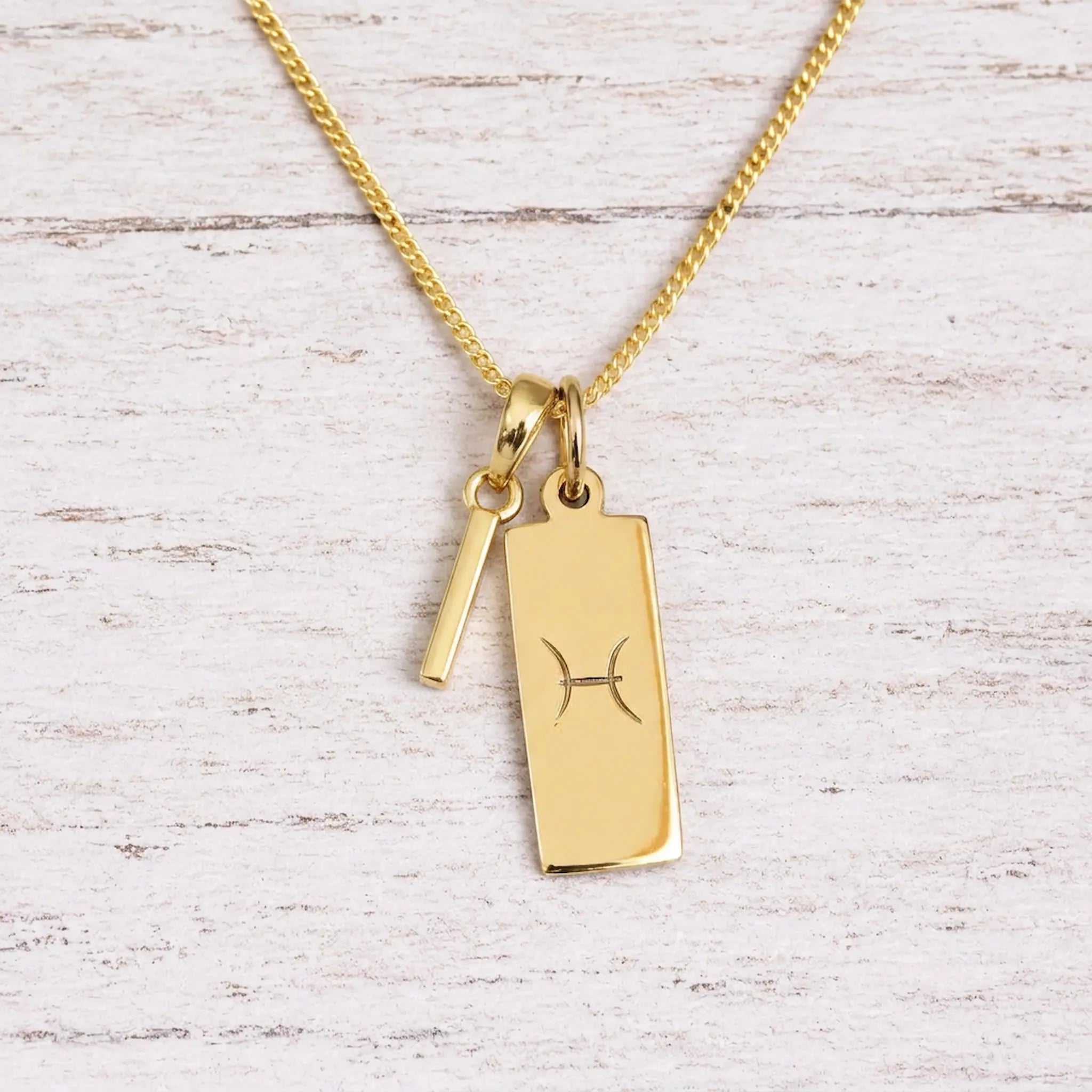 gold initial c pendant and pisces zodiac star sign pendant on a fine gold chain
