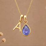 Gold Initial A and December Birthstone natural Tanzanite Necklace on a warm background