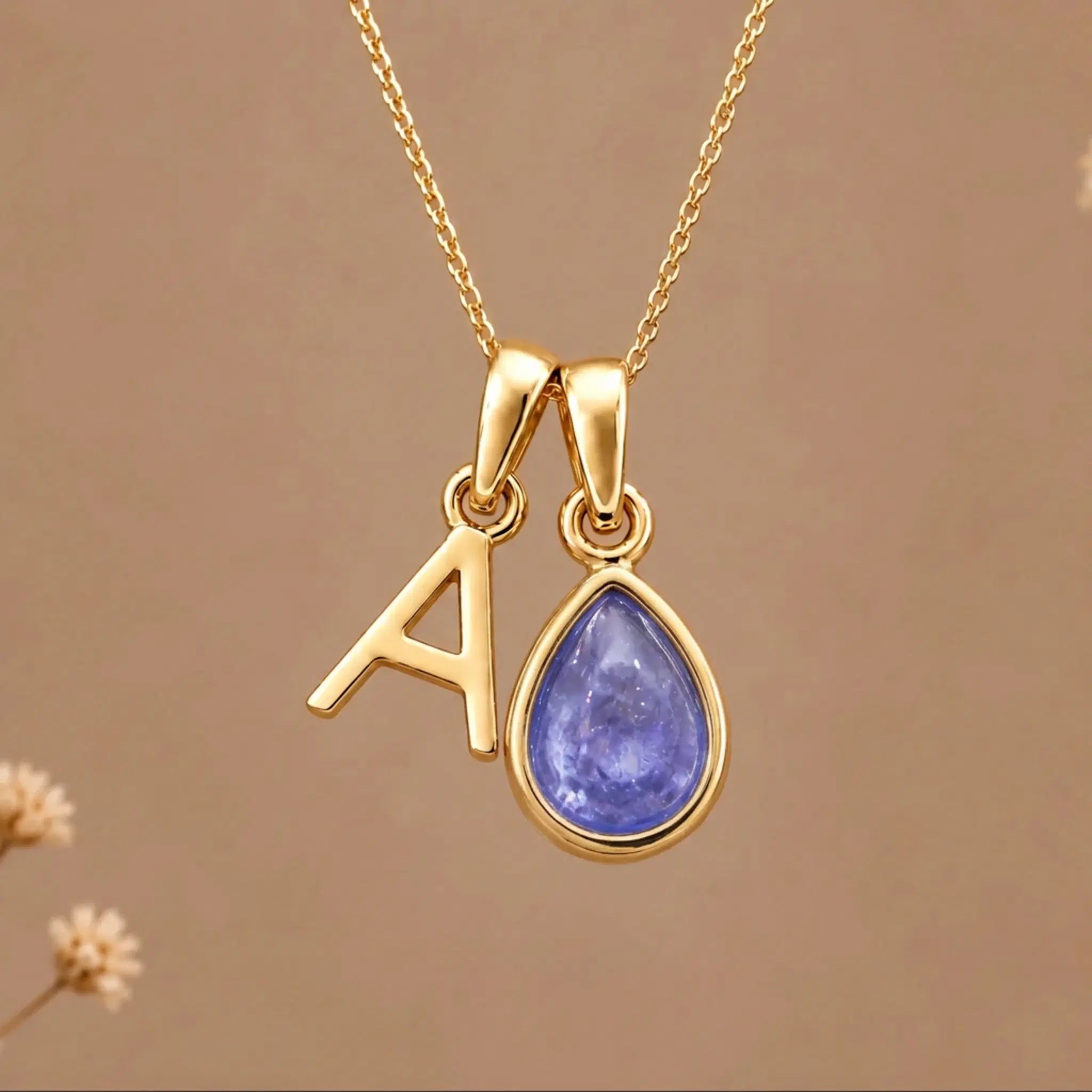Gold Initial A and December Birthstone natural Tanzanite Necklace on a warm background