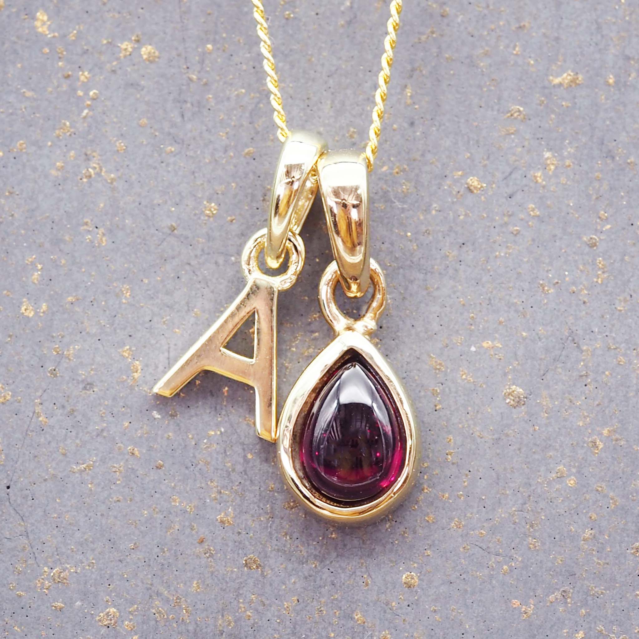 gold initial pendant and january birthstone garnet necklace by indie and harper australia