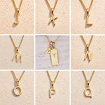 grid of Gold fine chain necklaces with uppercase initial charms J to Q on a beige background as personalised gold letter pendant options on a Aries Zodiac Necklace.