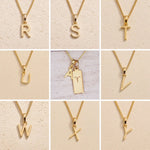 grid of Gold fine chain necklaces with uppercase initial charms R to Y on a beige background as personalised gold letter pendant options on a Aries Zodiac Necklace.