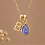 Gold Initial B and December Birthstone natural Tanzanite Necklace on a warm background