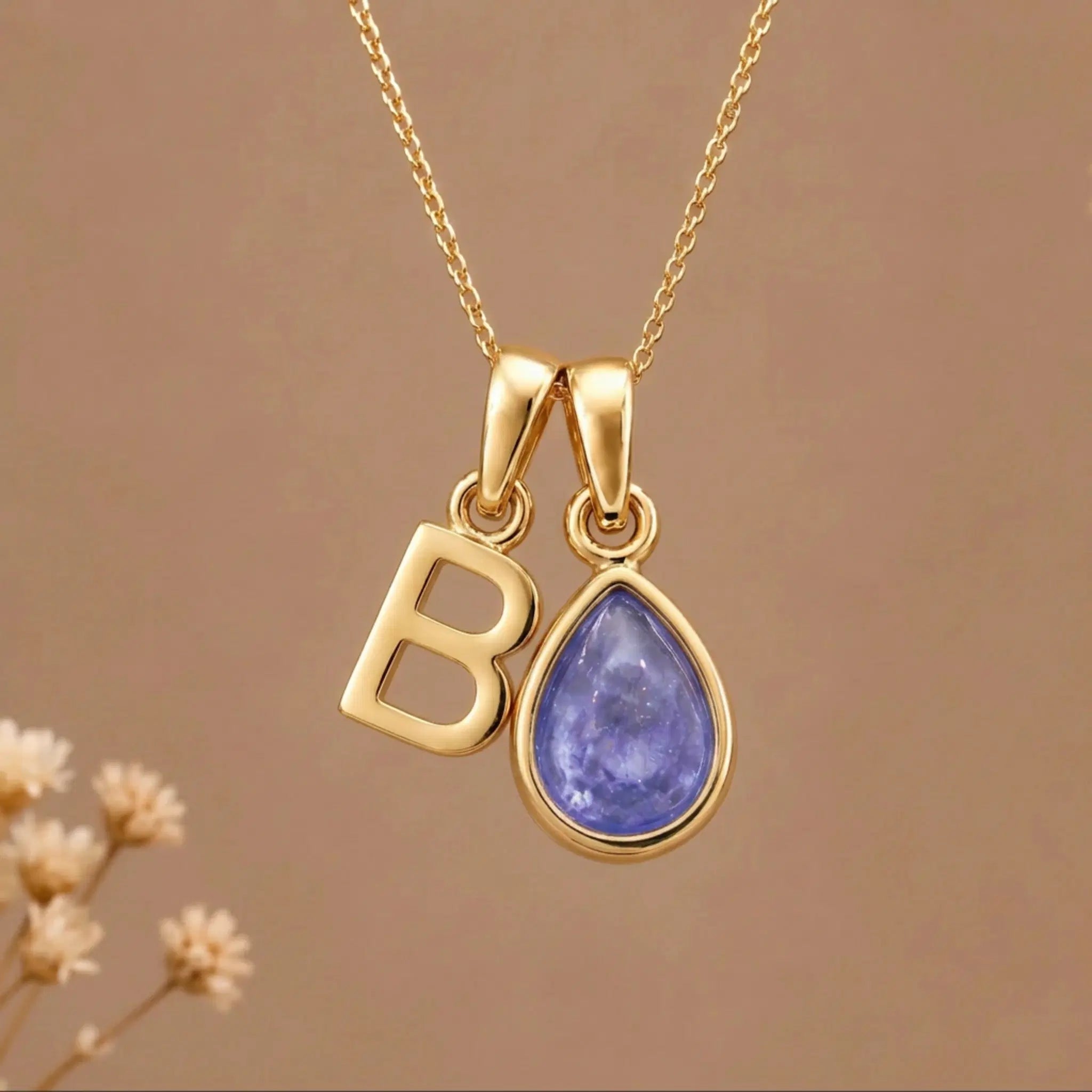 Gold Initial B and December Birthstone natural Tanzanite Necklace on a warm background