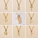 Collage of gold necklaces with letters R to Y on a beige background as gold letter charm options for personalised Capricorn Zodiac Necklace