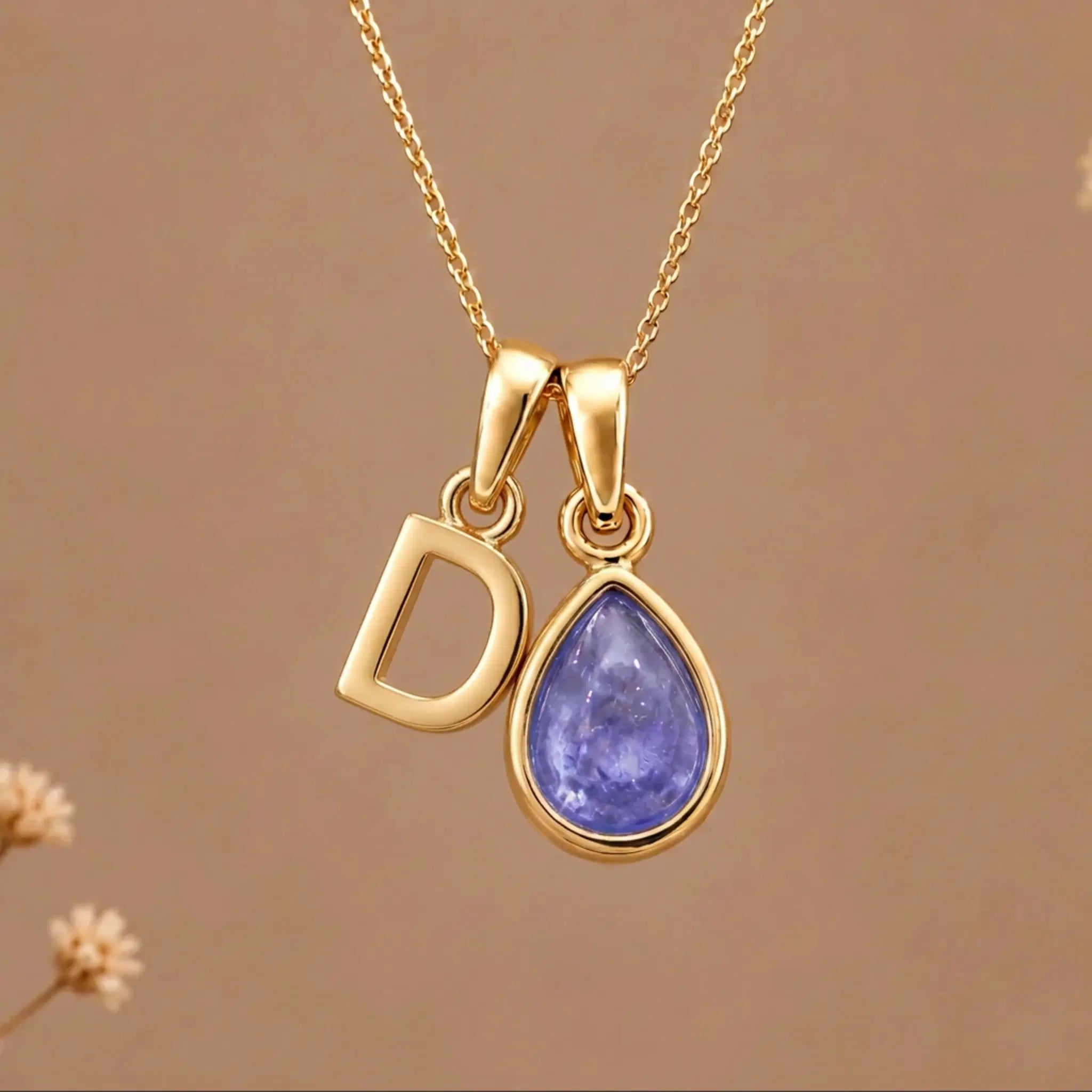 Gold Initial D and December Birthstone natural Tanzanite Necklace on a warm background