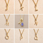 Grid of Fine Gold Chain Necklaces with uppercase Initial Letter Pendants J, K, L, M, A, N, O, P, Q as personalised options for December Birthstone Tanzanite Necklace on a light background.