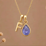 Gold Initial F and December Birthstone natural Tanzanite Necklace on a warm background