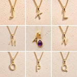 Gold chain necklaces with letter pendants J to Q on a beige background, as personalised gold letter options for the Gold February Birthstone Amethyst Necklace.