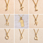 Gold chain necklaces with letter pendants J to Q on a beige background as Gold Letter Pendant Options to personalise the Gemini Zodiac Necklace.