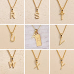 Gold chain necklaces with letter pendants R to Y on a beige background as Gold Letter Pendant Options to personalise the Gemini Zodiac Necklace.